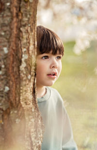 Portrait of young woman standing in forest