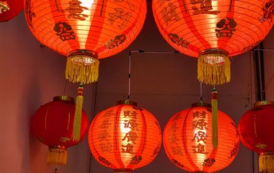 Low angle view of illuminated lanterns hanging on ceiling