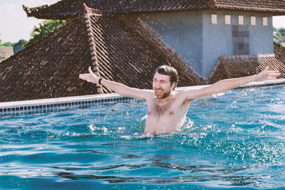 Portrait of smiling man in swimming pool