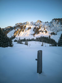 Scenic view of snowcapped mountains against clear sky