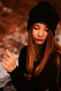 Close-up of thoughtful young woman on field