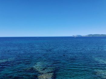 Scenic view of sea against clear blue sky