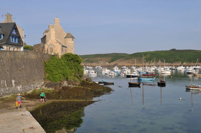 Boats in historic building against clear sky