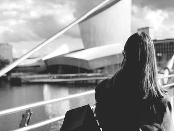 Rear view of woman on boat against sky