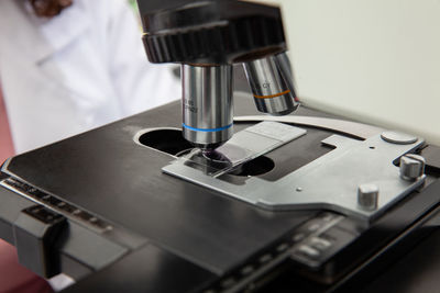 Scientist looking at liquid based cytology pap smear samples through a microscope. 