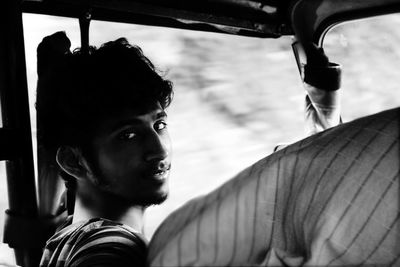 Portrait of young man sitting in vehicle