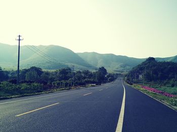 Empty country road against clear sky