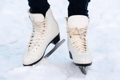 Woman skating at ice. close up of feet with ice skates on