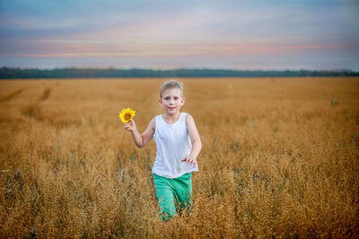 Portrait of smiling girl on field