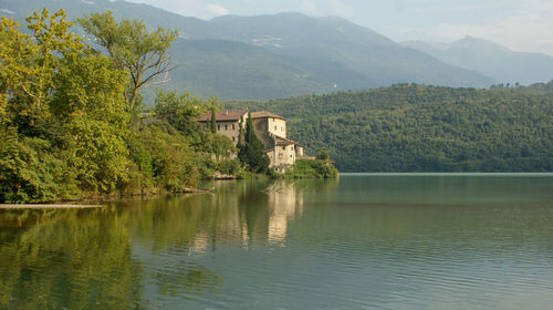 Scenic view of lake by trees and mountains