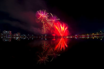 Firework display over city at night