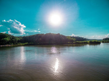 Scenic view of lake against bright sun