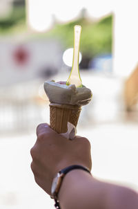 Close-up of hand holding ice cream