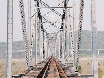 Railroad tracks against bridge