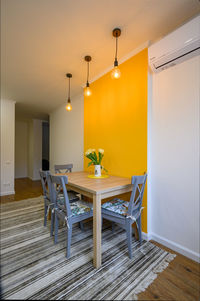 Empty chairs and table against wall at home