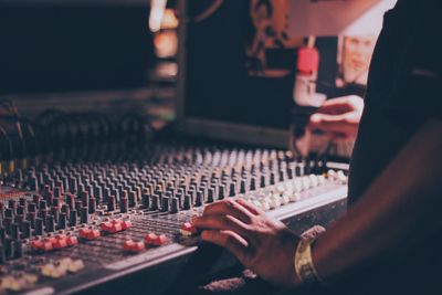 Close-up of hand using sound mixer