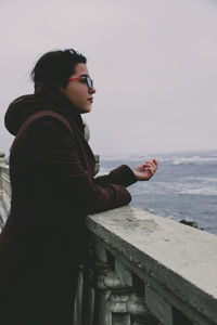 Man looking at sea against clear sky