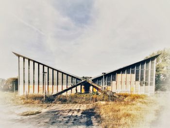 View of bridge on field against sky