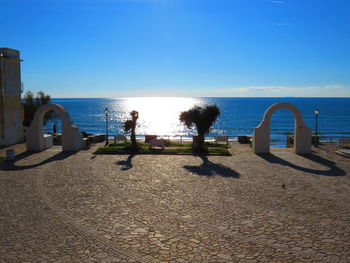 Scenic view of beach against blue sky