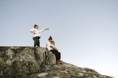 Family relaxing on rocks