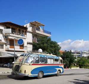 Car on street against buildings in city