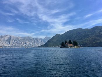 Scenic view of sea and mountains against sky 