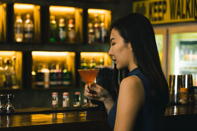 Young woman drinking glass