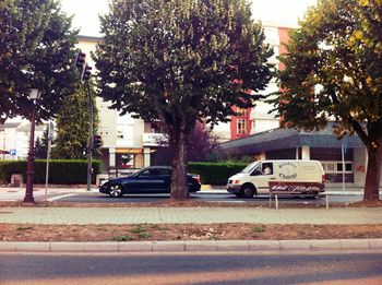 Cars on street by buildings in city