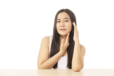 Portrait of a smiling young woman over white background