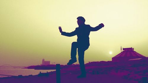 Silhouette of woman at sunset