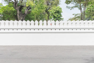 View of white fence on footpath