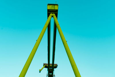 Low angle view of yellow structure against blue sky