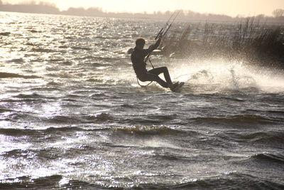 Side view of man jumping in sea