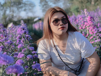 Portrait of beautiful woman with pink flower