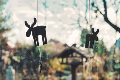Close-up of figure of elk hanging on window