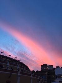 Low angle view of buildings against sky during sunset