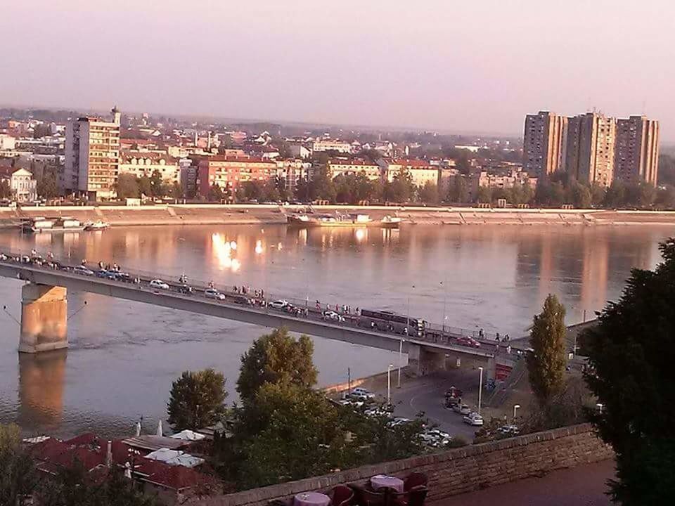 HIGH ANGLE VIEW OF ILLUMINATED BRIDGE OVER RIVER