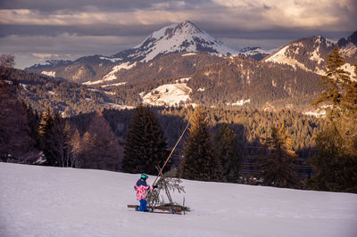 Scenic view of snowcapped mountains against sky during sunset