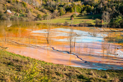 Lake polluted with toxic red residuals from copper exploitation, geamana, rosia montana, romania