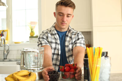 Midsection of man eating food