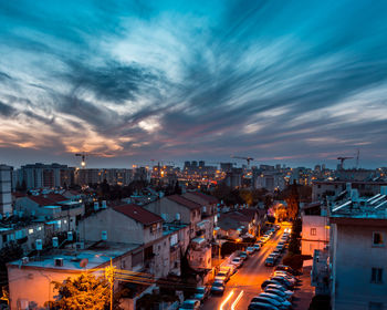 High angle view of illuminated buildings against sky at night