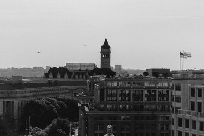 Buildings in city against clear sky