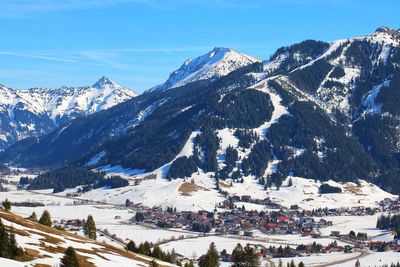 Scenic view of snow covered mountains against sky