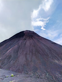 View of volcanic mountain against cloudy sky