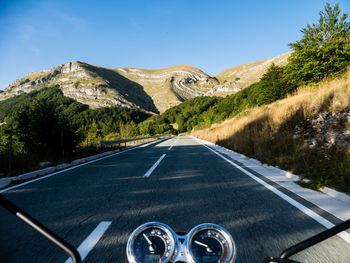 Driver's view of a motorcycle riding on a country road in the mountains