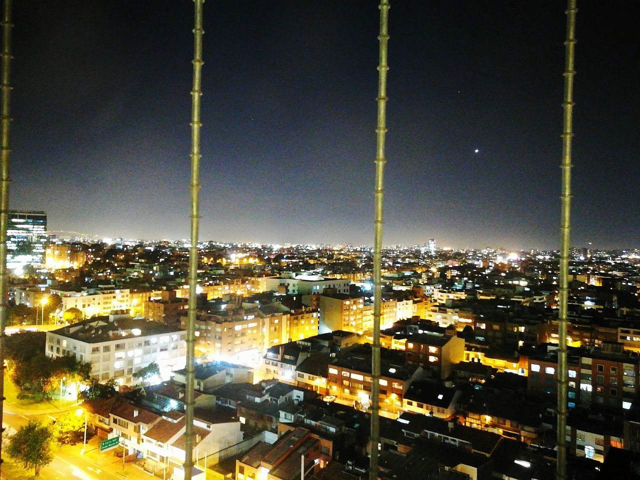 ILLUMINATED CITYSCAPE AGAINST SKY