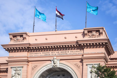 Low angle view of flag against blue sky