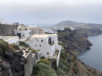 High angle view of white buildings by sea against sky