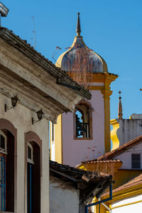 Low angle view of old building against clear blue sky