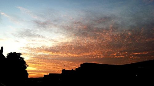 Low angle view of silhouette trees against sky at sunset